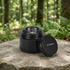 Portable mini alcohol stove with a forest background