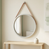 Silver strap mirror in a clean minimalist room